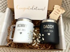 two personalized coffee mugs in a gift box with congratulations cards and a note