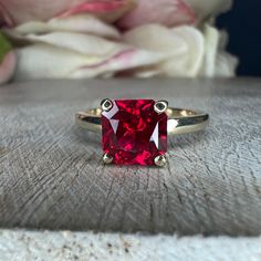 "This ring is a radiant cut lab created ruby with open u setting solitaire, 14k yellow gold #6217 This ring can be made with many different stone colors Message us for pricing on different color/type stones **Ruby is birthstone of July** -Approximate total carat weight: 2.10ctw diamond equivalent -Center Stone Size: approx. 1.75 ct diamond equivalent -Center Stone Shape: radiant 7x7mm -Gem Type: lab created ruby -Stone Clarity: AAA -Stone Color: red -Moh's Scale: 9 hardness -Metal Type and Purit Fine Jewelry Ruby Ring With Radiant Cut Center Stone, Radiant Cut Ruby Ring In Fine Jewelry Style, Radiant Cut Ruby Ring Fine Jewelry, Radiant Cut Ruby Ring With Center Stone, Red Rectangular 14k Gold Ring, Emerald Cut Solitaire Ruby Ring In Fine Jewelry Style, Ruby Ring With Radiant Cut Center Stone For Gift, Gift Ruby Ring With Radiant Cut, Radiant Cut Ruby Promise Ring With Prong Setting