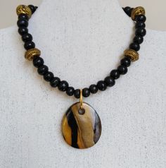 I've used the Japanese  technique mokume gane to create this polymer clay pendant. It comprises gold, white and black polymer clay. The pendant has been teamed with black wooden beads and golden spacer beads. The necklace is closed with a lobster claw lock and extends to 48cm if using the extender chain. The pendant measures 4.2 x 3.5cm. For more jewellery in similar colours, see the polymer clay section. Black Polymer Clay, Mokume Gane, Polymer Clay Necklace, Polymer Clay Pendant, Clay Necklace, Pendant Gold, Chain Styles, Spacer Beads, Wooden Beads