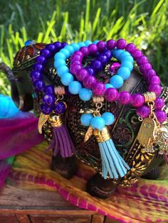 "Go ahead & embellish yourself with this years latest fashion in arm candy with my unique design of bohemian style, prayer bead stackable bracelets!   Choose from every color of the rainbow & see for yourself just what this trendy little style & mix can do for you!!   EACH UNIQUE BRACELET IS BEAUTIFULLY CREATED WITH:  Super strong & durable stretch cord to withstand daily wear ~~22 8mm acrylic colored beads, plus 3 additional hanging acrylic beads 2 Hanging gold charms (1 small & 1 big)  ~~1 mat Bohemian Blue Beaded Bracelets For Meditation, Blue Bohemian Bracelets For Meditation, Bohemian Blue Bracelets For Meditation, Blue Bohemian Beaded Bracelets For Meditation, Bohemian Beaded Bracelets With 8mm Beads, Bohemian Blue Friendship Bracelets With 8mm Beads, Bohemian Stretch Bracelet With Colorful Beads For Meditation, Bohemian Purple Beaded Bracelets Hand Wrapped, Bohemian Purple Friendship Bracelets For Festival