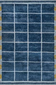 a blue rug with yellow and grey squares