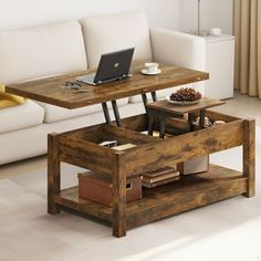 a coffee table with open drawers and a laptop on top