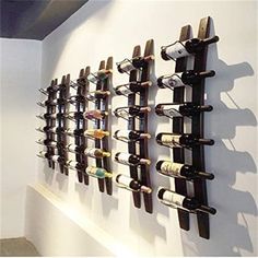 several wine bottles are hanging on the wall