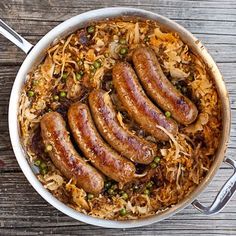 sausages and sauerkraut in a pan on a wooden table