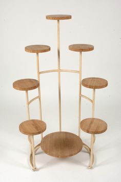 a set of four wooden stools sitting on top of each other