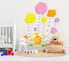 a child's room with a teddy bear and wall decals