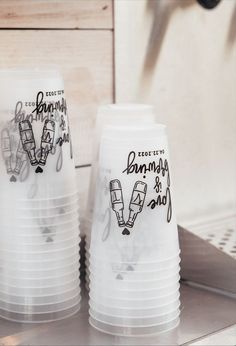 two plastic cups sitting on top of a counter