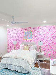 a bedroom with pink hearts painted on the wall