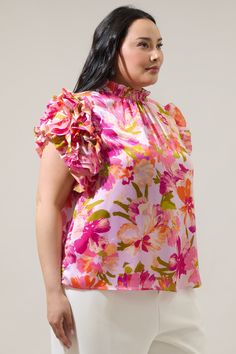 Show off your effortlessly sweet style in the Abigal Floral Brenna Mock Neck Ruffle Blouse! Our favorite blouse takes shape featuring a smocked, mock neck. Ruffle layered short sleeves steal the show while framing a relaxed bodice that can be styled tucked into your favorite high waisted bottoms.- Mock neck- Ruffle layer sleeves- Keyhole- Classic fit- Color: Coral MultiSize + Fit - Model is 5'10" and wearing size 2X- Measurements taken from size 2X - Chest: 49 1/2"- Length: 26 1/2" Fabric Self: Feminine Top With Smocked Bodice And Flutter Sleeves, Feminine Tops With Smocked Bodice And Flutter Sleeves, Feminine Blouse With Smocked Bodice And Flutter Sleeves, Spring Pink Blouse With Smocked Back, Feminine Spring Blouse With Smocked Back, Spring Flutter Sleeve Blouse, Pink Smocked Back Blouse For Spring, Pink Blouse With Smocked Back For Spring, Feminine Top With Smocked Back And Flutter Sleeves