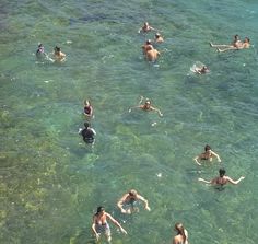 many people swimming in the ocean together