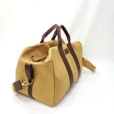 "This Travel Bag is made from 18 oz harvest tan canvas with brown leather trims. SIZE: 20\" wide x 13\" Tall x 11\" depth Features: 2\" adjustable cross bodyt strap (Removable) 2 sides handles Inside zipper pocket 9\"x10\" Metal tooth zipper for long lasting use Stitched with nylon tread for durability. ♡ PROCESSING TIME: Your travel bag will ship within 1-3 business day after purchase. ♡ SHIPPING TIME: 2-5 business days within the US via UPS. ♡ GIFTS: You can ship our products directly to your Brown Large Capacity Canvas Satchel Bag, Khaki Canvas Travel Bag, Khaki Canvas Bag For Travel, Large Canvas Shoulder Bag For Overnight Trips, Beige Rectangular Canvas Bag For Outdoor, Canvas Shoulder Bag With Large Capacity For Overnight Trips, Brown Waxed Canvas Duffle Bag For Travel, Canvas Shoulder Bag With Leather Handles For Overnight Trips, Outdoor Large Capacity Duck Canvas Bag