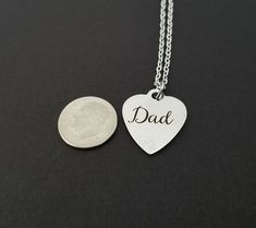 "Personalized Stainless Steel Dad Necklace! A heart shaped charm engraved with \"Dad\" on a bright silver chain makes the perfect gift for your dad. The fathers day necklace charm is made from stainless steel and measures 19 mm by 22 mm. The chain is silver plated and measures 16\" or 18\" with a 1\" extender. You can also personalize your necklace with a .5\" silver plated disc stamped with the initial of your choice. To see other stainless steel charms, click here: https://www.etsy.com/shop/Th Father's Day Engraved Sterling Silver Charm Necklaces, Father's Day Engraved Sterling Silver Charm Necklace, Engraved Sterling Silver Charm Necklaces For Father's Day, Personalized Heart Jewelry For Father's Day, Meaningful Heart Jewelry For Father's Day, Engraved Heart Necklaces For Father's Day, Heart-shaped Engraved Necklaces For Father's Day, Father's Day Heart-shaped Engraved Necklaces, Silver Heart Necklace As Father's Day Gift