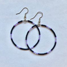 These handmade, beaded hoop, earrings come in a variety of colors. This pair is black with a purple gradient. Perfect for all occasions and super comfortable to wear. These earrings are not heavy at all and can be worn comfortably all day. The earrings are 5 cm across. Every pair is unique and  may look somewhat different than the picture. I love making these earrings and hope you enjoy wearing them! Handmade Black Beaded Small Hoop Earrings, Black Hoop Earrings With Colorful Beads For Gift, Black Hoop Earrings With Colorful Beads As Gift, Black Beaded Round Hoop Earrings, Small Black Hoop Earrings For Jewelry Making, Gift Black Hoop Earrings With Colorful Beads, Adjustable Hoop Earrings With Black Beads, Adjustable Black Beaded Hoop Earrings, Bohemian Purple Hoop Earrings With Round Beads