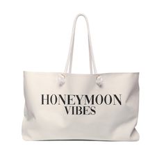 a white tote bag with the words honeymoon vibes printed in black on it