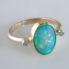 Fine Jewelry Oval Cabochon Opal Ring, Oval Cabochon Opal Ring Fine Jewelry, Oval Cabochon Opal Ring In Fine Jewelry, Classic Oval Opal Ring With Bezel Setting, Classic Oval Bezel Set Opal Ring, Oval Opal Rings With Polished Finish, Heirloom Oval Opal Ring With Polished Finish, Oval Cabochon Opal Multi-stone Jewelry, Fine Jewelry Oval Opal Ring With Polished Finish