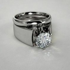 a couple of rings that are on top of each other with a diamond in the middle