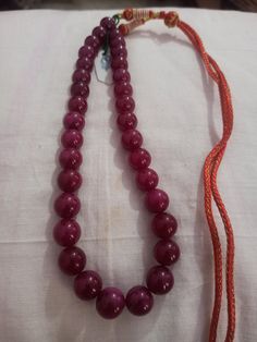 Ruby Necklace Natural Ruby Corundum Smooth Round Beads 513 Carat AAA Ruby Necklace With Adjustable Code Necklace 1.Ruby Corundum 2. Ruby Round Beads 3. 14 inches length, 1 Line String 4. 513 -carat weight 5. 10x10 - 12x12 mm stone size 6, The necklace is with tassel because you can easily adjust your necklace length. 7. If you want any changes in the necklace example if you want with clasp we can do it. Polish :- Handmade Purity :- AAA These natural Ruby gemstones can be used to make different j Gift Polished Round Beads, Round Faceted Beads, Handmade Temple Jewelry Pearl Necklace With Round Beads, Traditional Purple Beaded Necklace With Round Beads, Traditional Round Beaded Necklaces For Formal Occasions, Traditional Round Beaded Necklace For Formal Occasions, Traditional Beaded Necklace For Formal Occasions, Temple Jewelry Necklaces With Polished Beads, Pearl Necklace With Large Beads As Gift