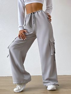 Experience the perfect blend of comfort and style with our Flap Pocket Waist Cargo Pants. These casual jogger pants in a trendy light gray shade are designed to elevate your fashion game. The extra-long length and regular fit ensure a flattering silhouette, while the drawstring and pocket details add a touch of functionality. Details: Color: Light Gray Style: Casual Pattern Type: Plain Type: Jogger Details: Drawstring, Pocket Length: Extra Long Fit Type: Regular Fit Fabric: Non-Stretch Material: Gray Sweatpants For Leisure In Spring, Gray Leisure Sweatpants For Spring, Trendy Gray Wide Leg Pants, Trendy Gray Pants For Spring, Trendy Gray Joggers For Leisure, Gray Leisure Pants For Spring, Gray Pants For Leisure In Spring, Baggy Gray Sweatpants For Spring, Baggy Gray Pants For Leisure