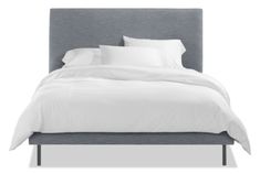 a bed with white sheets and pillows on it's headboard, against a white background