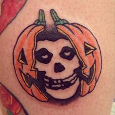 a skull with a pumpkin on it's head is shown in this tattoo design