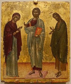 an icon with three men standing next to each other and one man holding a book