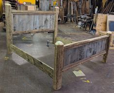 a bed frame made out of wood in a workshop