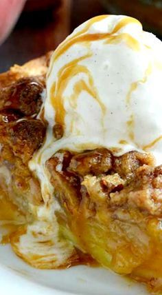 a piece of pie with ice cream on top and caramel sauce drizzled over it