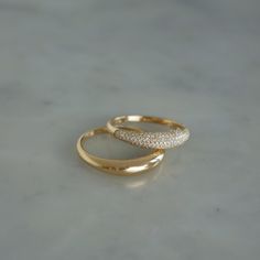 Bold is the way to go. Stacked or separate, these beautiful rings will do the talking for you.The Dome Duo Gift Set includes: The Gold Dome Ring: Keep it simple while making a statement in our 14k gold dome ring. The Diamond Dome Ring: With pavé diamonds and 14k gold, this dome ring takes style to new heights. $2,300 value which means you save 15% and a whole bunch of time since we did the styling for you. There’s something to be said about a solo moment, but we believe style should be stacked. Jewellery Rings Gold, White Gold Band Ring, Round Rings Gold, Dome Wedding Ring, Dome Gold Ring, Daily Ring Stack, Elegant Dome Ring With Vs Clarity For Wedding, Elegant Wedding Dome Ring, Vs Clarity, Gold Domed Ring With Brilliant Cut