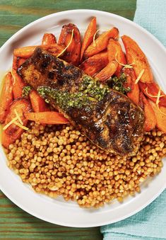 a white plate topped with meat, carrots and lentils