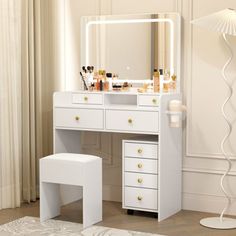 a white dressing table with drawers and a mirror