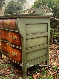 an old dresser is painted green and gold