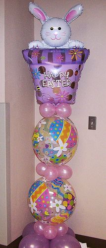 a bunch of balloons that are stacked on top of each other in the shape of an easter basket