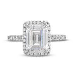 an emerald - cut diamond ring with pave set shoulders and halos around the band