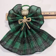 a piece of cloth with a bow on it next to a ruler