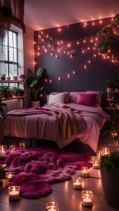 a bedroom decorated with candles and pink blankets