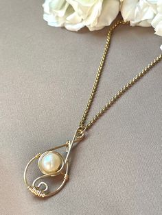 "Wear this necklace for its elegant handmade freshwater pearl teardrop wire handmade pendant. Great for holiday gift, gift for mom, gift for sister, gift for wife, gift for girlfriends, etc.! 1.5\" total pendant height freshwater pearl non tarnish 20\" cable chain necklace hypoallergenic 18k gold plated" Wire Wrapped Pearl Necklace, Handmade Teardrop Pearl Necklace Gift, Handmade Delicate Necklace With Teardrop Pendant, Pearl Drop Necklace As Gift, Delicate Handmade Teardrop Pendant Necklace, Dainty Wire Wrapped Teardrop Necklace, Pearl Drop Necklace For Gift, Pearl Chain Drop Necklace With Teardrop Pendant For Gift, Dainty Teardrop Wire Wrapped Necklace