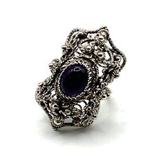 This ring is one of our new vintage collection items I discovered recently from another part of my family. The ring is a handmade filigree work from one of our family master jewelers and was revived in order to present this exceptional art. It was reconditioned and updated with a new Amethyst stone. The entire ring is hand made with filigree techniques used by my families filigree masters. The material used is sterling silver (925). This ring symbolizes the night on Adriatic beaches. Size: 5.5 L Vintage Purple Sapphire Gemstone Ring, Purple Anniversary Rings With Intricate Design, Purple Oval Filigree Rings, Vintage Crystal Gemstone Open Ring, Heirloom Amethyst Rings With Intricate Design, Heirloom Style Open Ring With Intricate Design, Vintage Open Crystal Gemstone Ring, Handmade Vintage Filigree Ring, Purple Oval Ring With Intricate Design