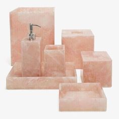 pink marble bathroom accessories including soap dispenser, soap dish and tissue holder