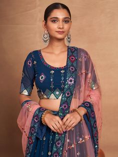 Introducing our stunning "attractive blue embroidered georgette function wear lehenga choli", a must-have for any special occasion. This exquisite ensemble features a blue georgette lehenga with intricate sequin work and embroidered detailing, a matching georgette choli with embroidery and sequin work, and a net dupatta in a similar color adorned with embroidery work, sequins, and a heavy lace border.
The lehenga is semi-stitched up to 42 inches with a 3.5-meter flair, while the choli material i Blue Fitted Anarkali Set For Party, Party Wear Embroidered Georgette Lehenga, Blue Bollywood Lehenga For Party, Blue Zari Work Choli For Party, Blue Anarkali Set With Pallu For Party Wear, Blue Designer Lehenga For Party Wear, Blue Choli With Dupatta For Party, Blue Lehenga For Diwali Party, Blue Party Wear Choli For Festive Occasions