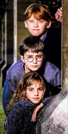 three young children are posing for a photo