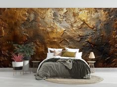 a bedroom with a large wall mural in gold and brown tones, along with two lamps