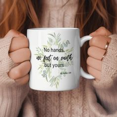 a woman holding a coffee mug with the quote no hands, no feet on earth but yours