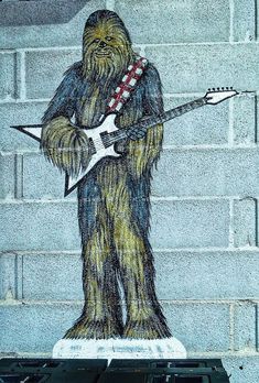 a star wars character is depicted on the side of a building with an electric guitar