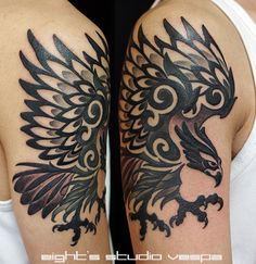 a black and white photo of a tattoo on someone's arm with an eagle