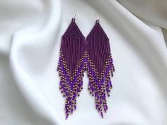 These purple bright beaded earrings are made from selected Japanese beads. Long seed bead earrings can be an excellent personalized gift for bridesmaids, Mother's Day, birthdays, Valentine's Day, Wedding day, Christmas, New Year, and for your loved ones. ♡ Length - 5.5'' (14 Centimeters) ♡ Width - 1.2'' (3 Centimeters) ♡ Quality Japanese beads ♡ 925 Silver hooks/Stainless steel I accept payments through Paypal. The colors can slightly differ from the photo because of photography lighting and mon Elegant Purple Beaded Earrings With Colorful Beads, Lavender Beaded Drop Earrings, Elegant Lavender Beaded Earrings With Dangling Beads, Lavender Drop Beaded Earrings, Purple Beaded Dangle Earrings With Tiny Beads, Purple Beaded Earrings With Dangling Round Beads, Elegant Handmade Lavender Beaded Earrings, Purple Dangle Beaded Earrings With Spacer Beads, Handmade Purple Beaded Drop Earrings