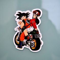 a sticker depicting two people riding a motorcycle with their arms around each other's shoulders