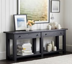 a black table with two drawers and some pictures on it