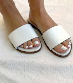 Elevate your style effortlessly with the simplicity of chic fashion in these versatile slide sandals, allowing you to pair them with anything from casual denim to a breezy summer dress. Whether you're strolling through the city streets or enjoying a leisurely day at the beach, these comfortable leather sandals are made for your every adventure. 100% Leather Imported Soft pillow sole Runs small and narrow; we recommend sizing up Rub with dry cloth | Karen Kane Leather Sandals in White, Size 36, P Comfortable Flat Everyday Sandals, Chic Flat Slides With Cushioned Footbed, Everyday Flat Sandals With Textured Footbed, Trendy Slides With Cushioned Footbed And Open Heel, Adjustable Flat Sandals, Everyday Flat Summer Sandals, Comfortable Everyday Sandals With Flat Heel, Comfortable Flat Heel Sandals For Everyday, Comfortable Everyday Flat Heel Sandals