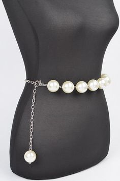 Elevate your outfit with our Iconic Pearl Station Chain Belt. Indulge in the luxury of genuine pearls and a delicate chain, adding a touch of elegance to any look. Complete your wardrobe with this timeless and sophisticated accessory. One Size Width - 1.25" Length - 50" PVC, Faux Pearl, Mix Metal Lead & Nickel Compliant Trendy Pearl Necklace With Chain For Parties, Trendy Pearl Necklace With Chain, Elegant Metal Pearl Necklace For Party, Elegant Adjustable Chain Pearl Necklace, Elegant Adjustable Pearl Necklace With Chain, Pearl White Pearl Jewelry With Chain, Elegant Adjustable Chain Belt Gift, Chic Silver Jewelry With Pearl Chain, Elegant Adjustable Chain Belt As Gift