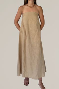 this linen strapless column dress is a must have for your summer wardrobe. crafted from a luxurious linen blend, this maxi dress offers a perfect combination of comfort and elegance. the strapless design and flowing silhouette create a chic and effortless look, ideal for warm weather occasions. whether you're heading to a beach party or a casual brunch, this versatile dress will keep you cool and stylish all day long. 80% linen | 20% viscose gentle wash cold | lay flat to dry | do not iron model Spring Beige Maxi Dress With Straight Neckline, Casual Maxi Dress With Straight Neckline, Beige Strapless Maxi Dress For Summer, Summer Strapless Beige Maxi Dress, Strapless Beige Maxi Dress For Summer, Beige Strapless Maxi Dress For Vacation, Strapless Beige Maxi Dress For Vacation, Solid Linen Maxi Dress For Vacation, Summer Beige Maxi Dress With Straight Neckline